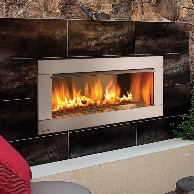 A Regency HZO42 outdoor gas fireplace on a table beside a cosy couch, one of the best gas fireplaces for autumn warmth