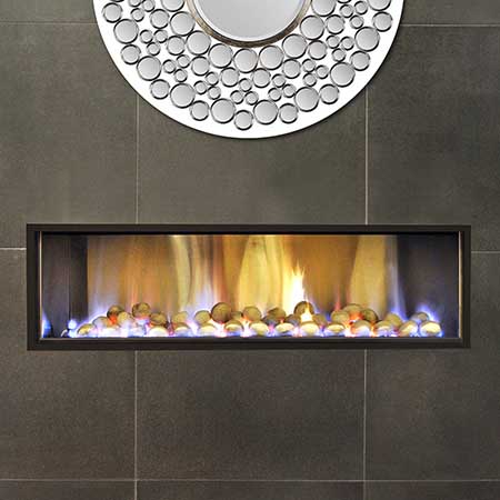A modern Horizon Low Line Inbuilt Fire with a mirror above it, adding warmth and style as one of the best gas log heaters for autumn