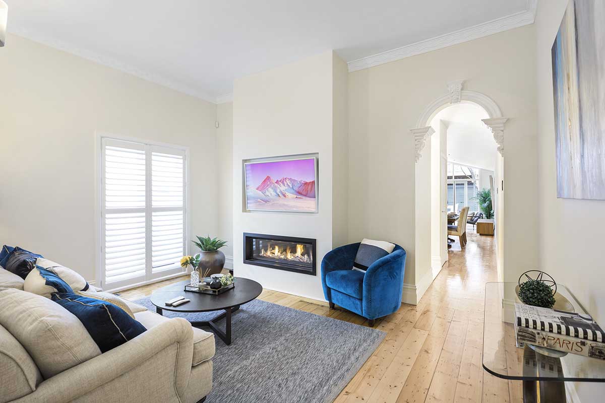 A stylish living room with a Real Flame Element 1200 fireplace and a plush couch for relaxation