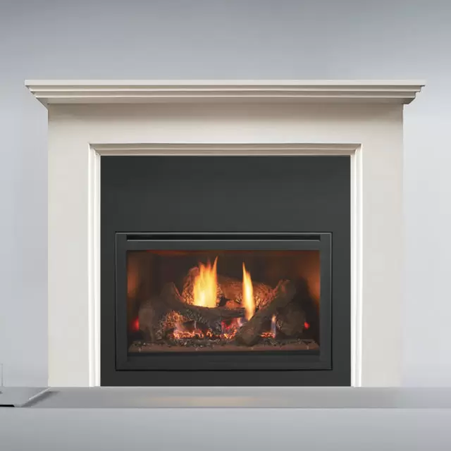Heat n Glo I25X Gas Fire set in a white mantle, with warm flames creating a cosy indoor atmosphere