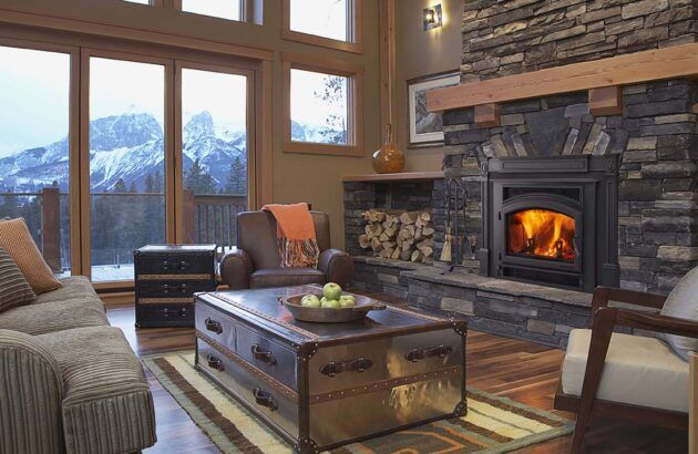 A warm living room with a Quadra-Fire Expedition II wood fireplace and inviting couches for relaxation