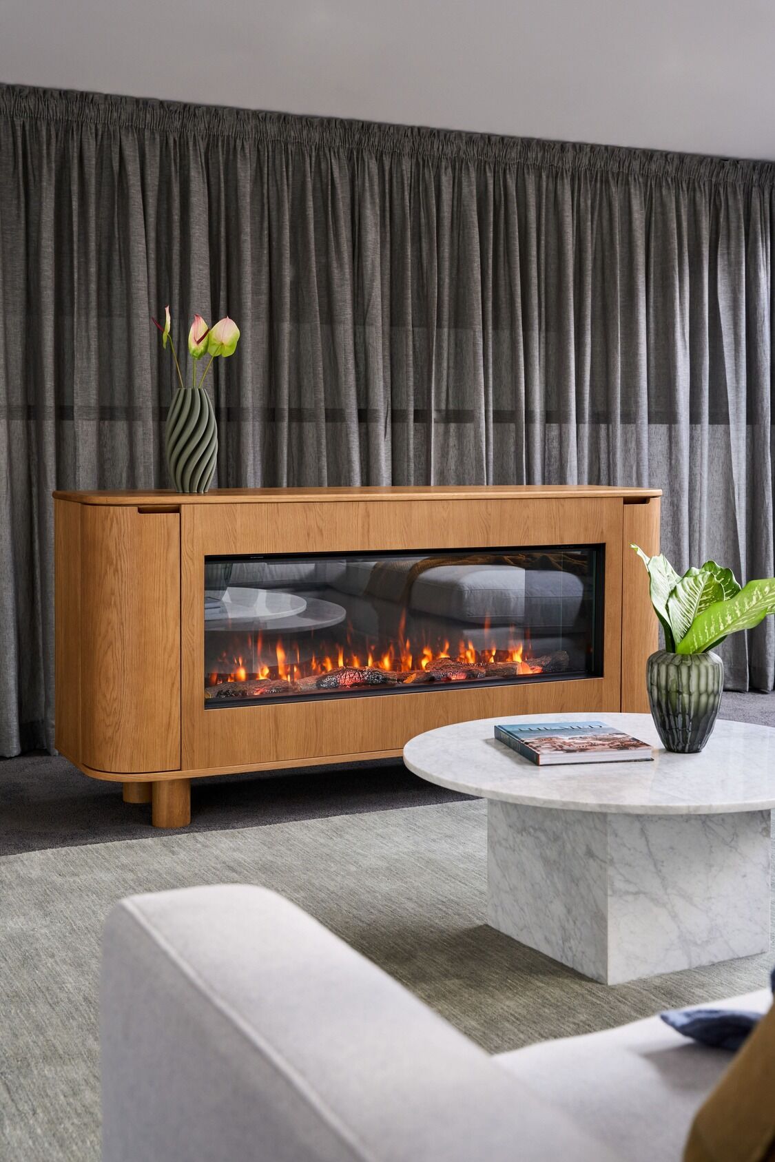 Contemporary living room with an EmberArc Ashton 180 electric fireplace and a comfortable couch, designed for relaxation