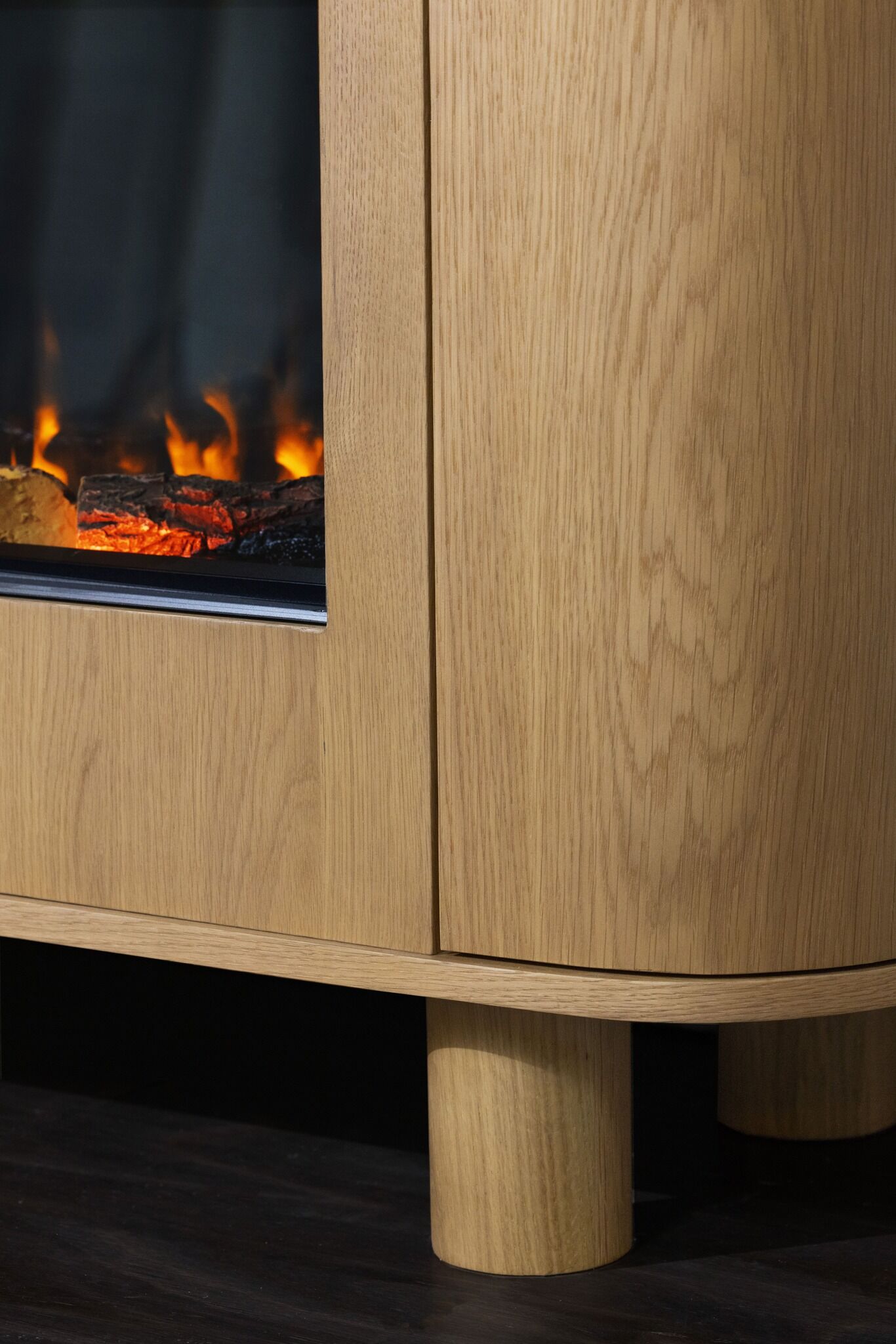 Close-up of wooden cabinet stand of Ember Arc Grange 180 electric fireplace, showing detailed finish and sturdy construction