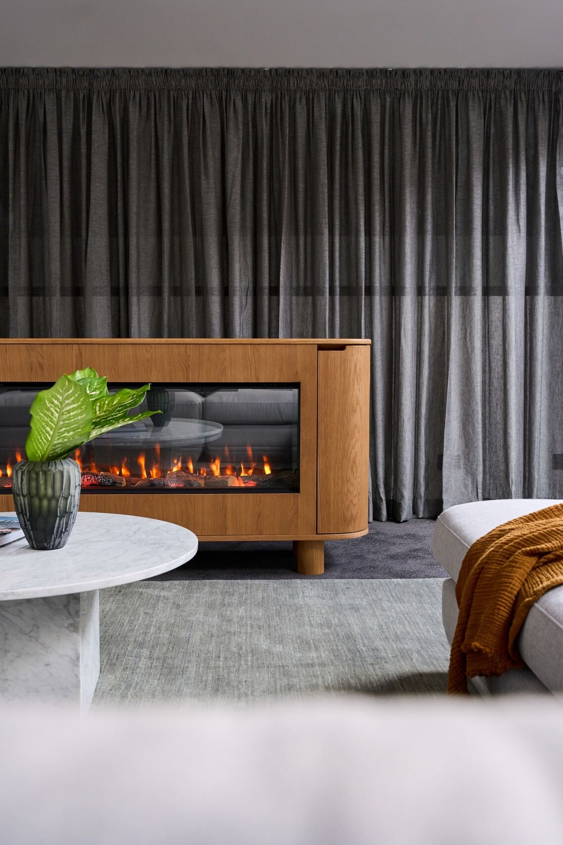 Contemporary living room with an EmberArc Ashton 180 electric fireplace and a comfortable couch, designed for relaxation