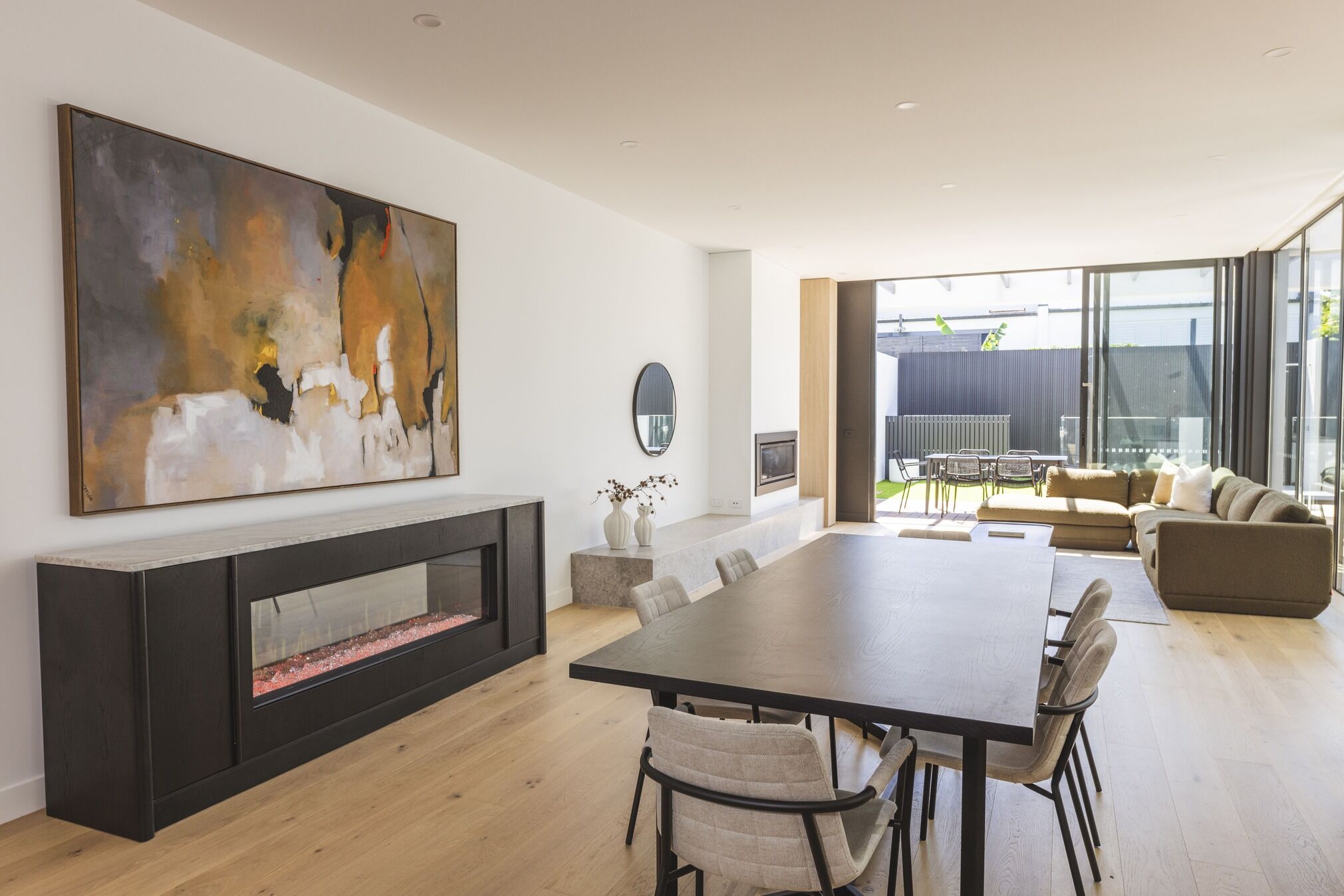 Modern living room with electric fireplace and wall art, with the Ember Arc Grange 240 adding warmth and style to the space