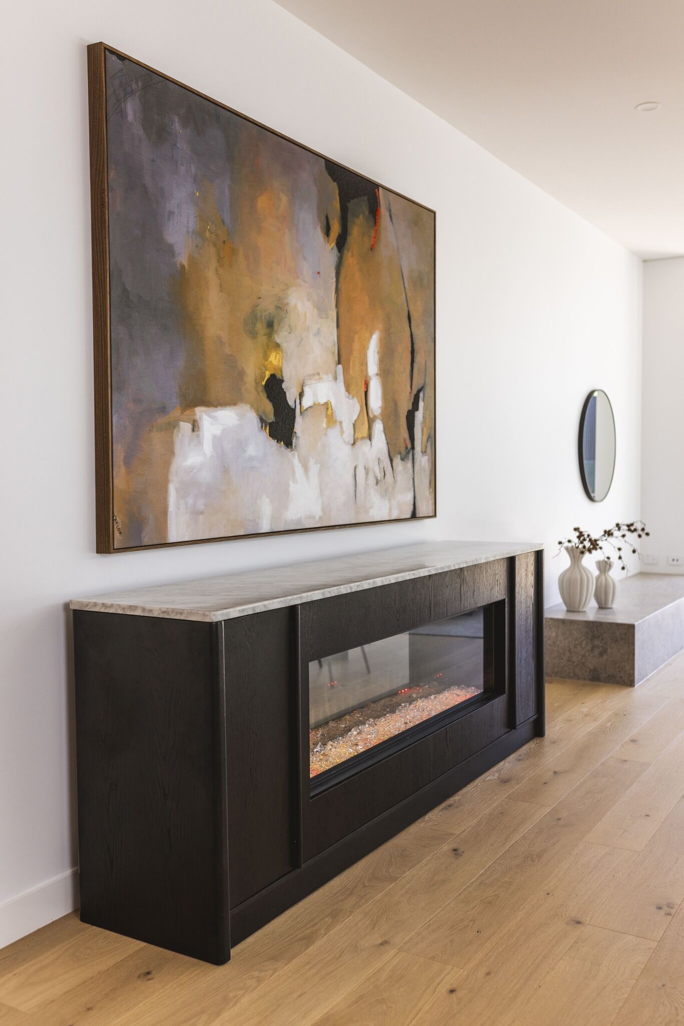 Modern living room with electric fireplace and wall art, with the Ember Arc Grange 240 adding warmth and style to the space